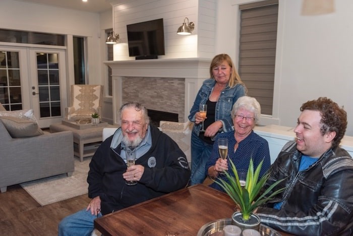  Albert Prendergast of Port Moody, the winner of the 2019 PNE Prize Home Grand Prize Package, celebrates in the house last night (Monday) with his partner, Maureen Newell, and daughter-in-law Laurie Newell and grandson Kyle Newell. Photo courtesy PNE