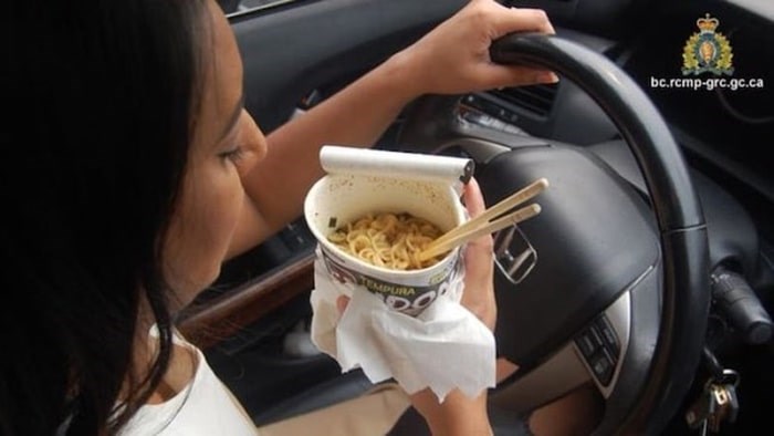  Back in 2017 Kelowna RCMP tweeted this picture of a woman eating noodles with chopsticks during Distracted Driving Awareness Month, warning that driving without due care could leave you more than $300 out of pocket. (This is not the woman who was fined.) Photo: RCMP
