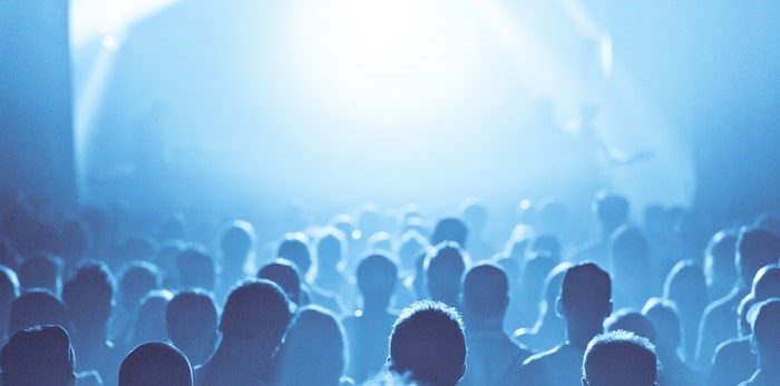  Crowd in silhouette during a live music show/Shutterstock