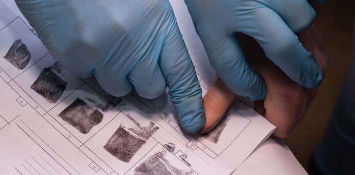  Crime suspect has fingerprints taken/Shutterstock