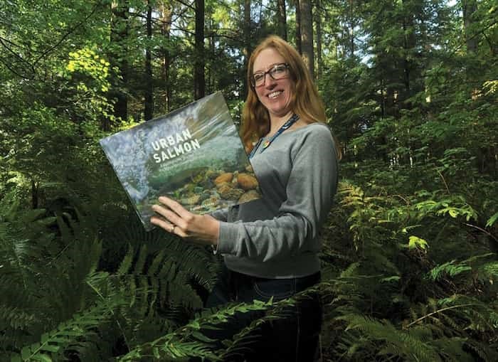  Cassie Allard of the Lynn Canyon Ecology Centre holds up a copy of Fernando Lessa’s Urban Salmon: A Photographic Journey into the Metro Vancouver Watershed. Lessa is giving a presentation at the ecology centre on Oct. 5. Photo: Mike Wakefield / North Shore News