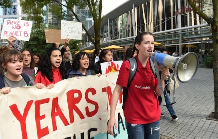  Lilah Williamson 15-year-old from Burnaby leads the charge as students march through downtown Vancouver Sept. 20. Vancouver School Board has said it supports students taking part in climate strike activities Friday. Photo Dan Toulgoet