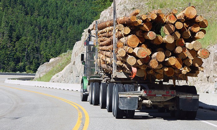  A logging truck with a full load on a road in B.C.. Photo Shutterstock