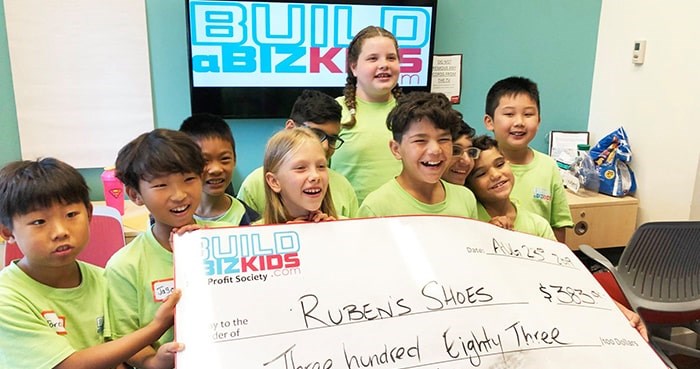  Build a Biz Kids participants with their business earnings. Photo: Build a Biz Kids.