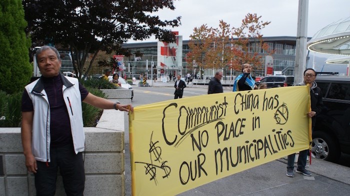  Protesters outside a Union of B.C. Municipalities reception hosted by the Chinese consulate say taking money from the Communist government is a way of buying influence. Protester Wing On Cheung of Richmond (right) called the reception 