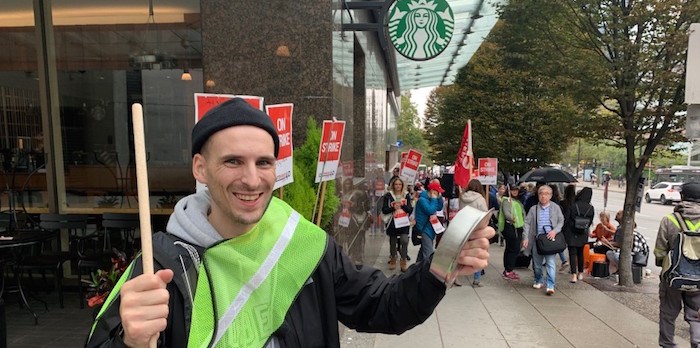 Union organizer Keith Malone holds a cowbell that he had been banging to make noise outside the Hyatt Regency to draw attention to the hotel workers being on strike. Photo by Glen Korstrom/Business In Vancouver