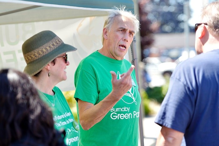  Coun. Joe Keithley speaks to members of the public at the Edmonds City Fair and Classic Car Show in July.