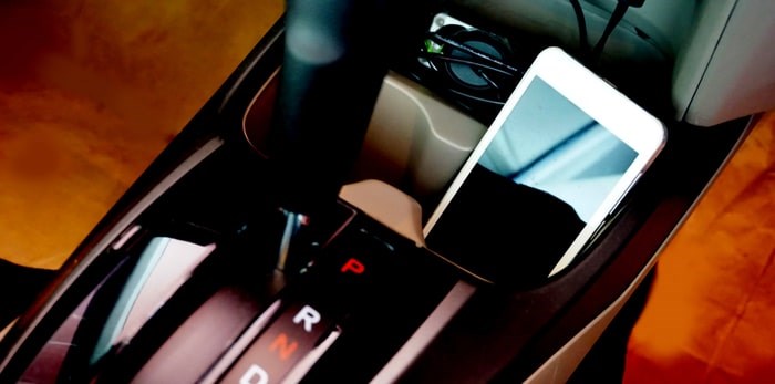  Cell phone in the cupholder of a car/Shutterstock