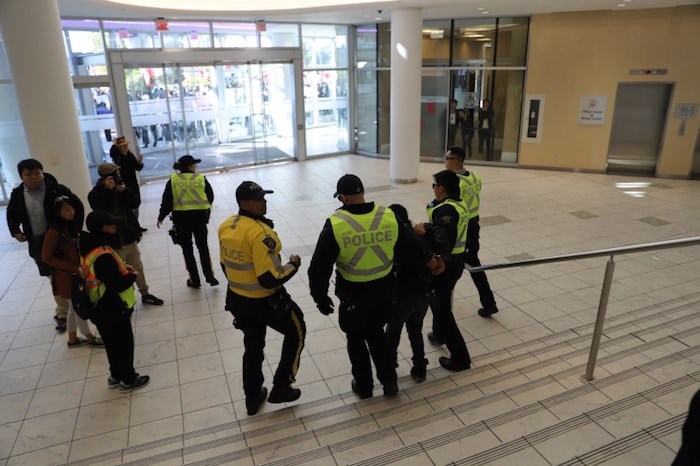  A man escorted away by Richmond RCMP and asked to leave the scene. Photo by Valerie Leung