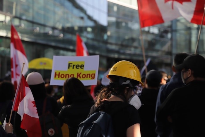  Pro-Hong Kong supporters were waving Canadian flags at the event. Photo by Valerie Leung 