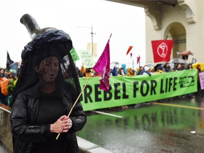  Between 100 and 200 climate activists convened on the centre span of the bridge Monday morning amid signs that read “Seas are rising, so are we” and “Change or die.” Photo Dan Toulgoet