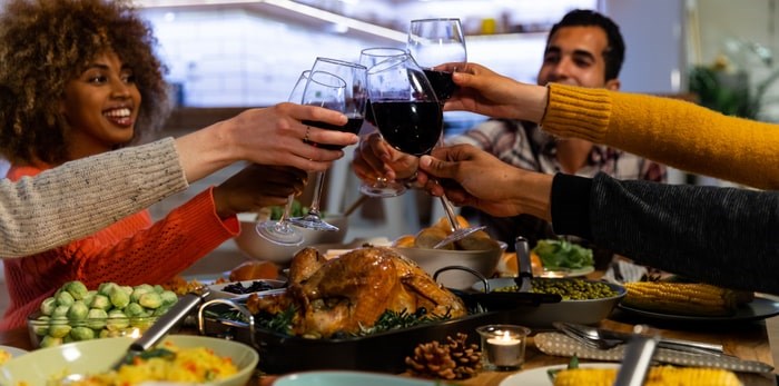  Wondering what wine goes with what? Cheers to this cheat sheet for pairing wines from B.C. with all the holiday meals and gatherings. Toasting over a holiday dinner/Shutterstock