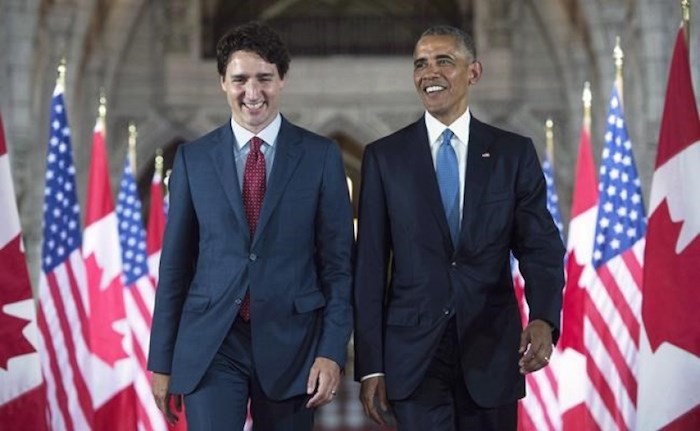  U.S. President Barack Obama and Prime Minister Justin Trudeau walk down the Hall of Honour on Parliament Hill, in Ottawa, June 29, 2016. In a message on Twitter, Obama says the world needs progressive leadership and he hopes Canadians will give Trudeau another term as prime minister. THE CANADIAN PRESS/Paul Chiasson