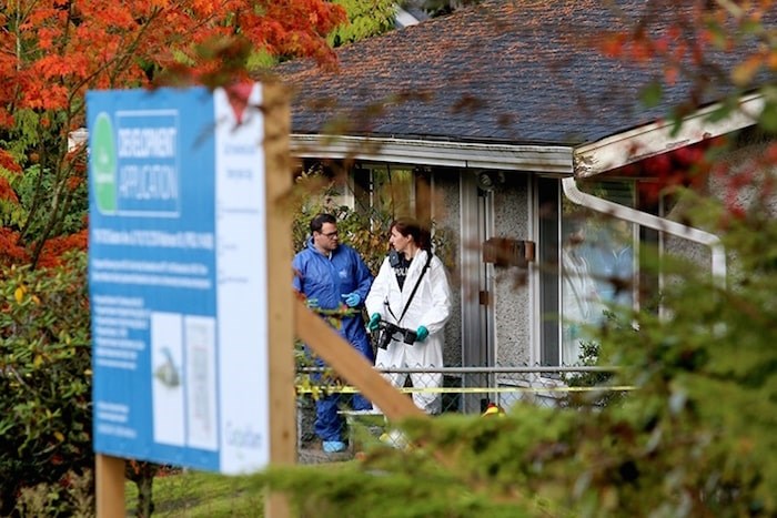  The Mounties are conducting an internal review following the deaths of an eight-year-old boy and his father last week in Coquitlam. Photo: Homicide investigators gathered evidence from a home at 719 Seaton Avenue in Coquitlam on Oct. 23. Mario Bartel/Tri-City News