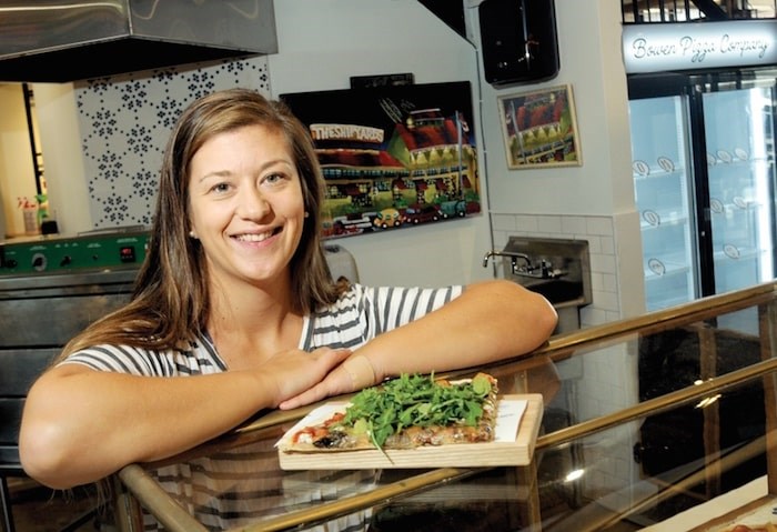  Bowen Island Pizza Company’s Melanie McCready displays a Truffle Shuffle (red sauce, seasonal mushrooms, arugula and a creamy cashew truffle sauce) – one of 20 options on the menu at the newly reopened Lonsdale Quay pizzeria. - Mike Wakefield, North Shore News