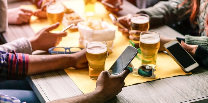  How are social media influencers shifting the culture of craft beer? Photo: Beer and cellphones/Shutterstock