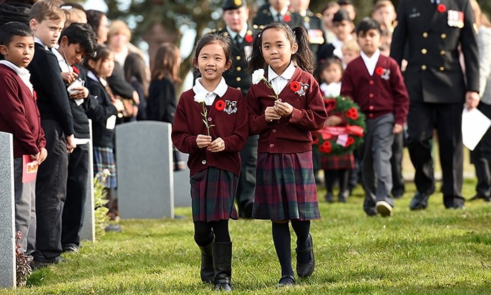  Students from St. Mary's elementary school, St. Francis de Sales, St. Catherine’s Langley and St. Helen’s School joined soldiers from the 39th Brigade to place poppies at veterans’ gravesites at Mountain View Cemetery on Wednesday. Photo Dan Toulgoet