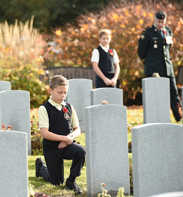  Students from St. Mary's elementary school, St. Francis de Sales, St. Catherine’s Langley and St. Helen’s School joined soldiers from the 39th Brigade to place poppies at veterans’ gravesites at Mountain View Cemetery on Wednesday. Photo Dan Toulgoet