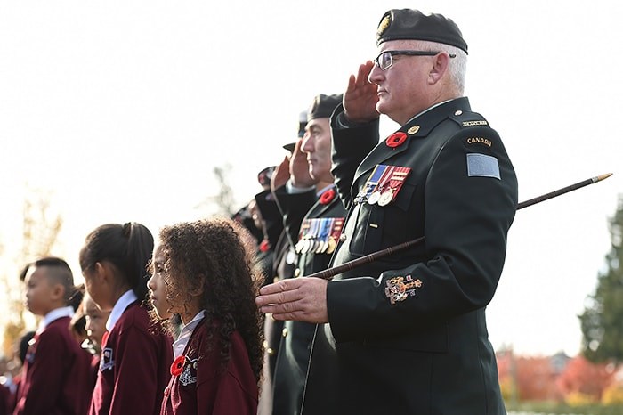  Students from St. Mary's elementary school, St. Francis de Sales, St. Catherine’s Langley and St. Helen’s School joined soldiers from the 39th Brigade to place poppies at veterans’ gravesites at Mountain View Cemetery on Wednesday. Photo Dan Toulgoet