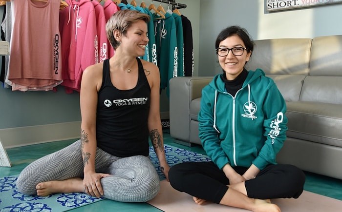  Yoga and fitness instructor Jessica Wild laughs with Shogofa Alizada, a Grade 12 student who left her home in Afghanistan in 2016 and was granted refugee status in Canada because she is from a persecuted minority. Wild is helping organize a fundraiser to support Alizada while she continues to finish school and apply for university. Photo by Diane Strandberg/Tri-City News