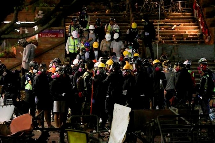  Protesters and parents gather at Hong Kong Polytechnic University campus in Hung Hom district, Hong Kong, Monday, Nov. 18, 2019. Police tightened their siege of a university campus where hundreds of protesters remained trapped Monday night in the latest dramatic episode in months of protests against growing Chinese control over the semi-autonomous city. (AP Photo/Ahmad Ibrahim)