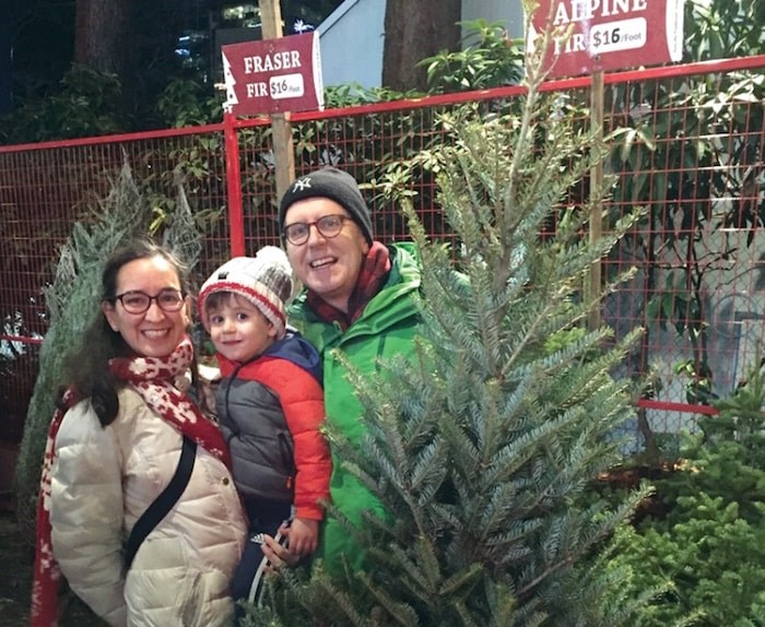  Lourdes Perez de Lara and her husband Graeme Conlon are joined by their son Martin in the Aunt Leah's Christmas tree lot at Lonsdale Quay. photo supplied