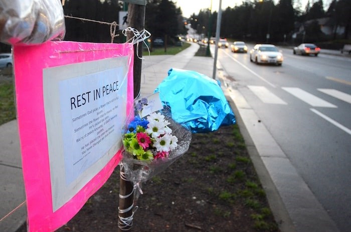  A memorial sprung up by a crosswalk at the bottom of Cariboo Hill after a 15-year-old girl was hit by a vehicle and killed while walking in the area. Photo by Cornelia Naylor