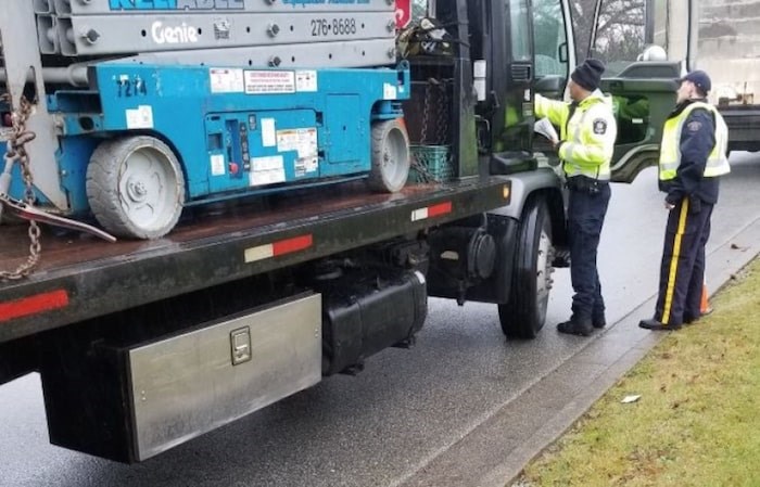  Burnaby RCMP inspecting trucks at Cariboo and 10 Avenue in Burnaby. Burnaby RCMP photo