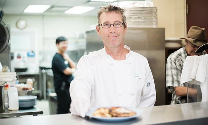  On Saturday, formerly homeless Vancouver chef Mike Miller will be busy in Union Gospel Mission’s kitchen helping to prepare the charity’s annual holiday feast.. Photo: UGM/Andrew Taran