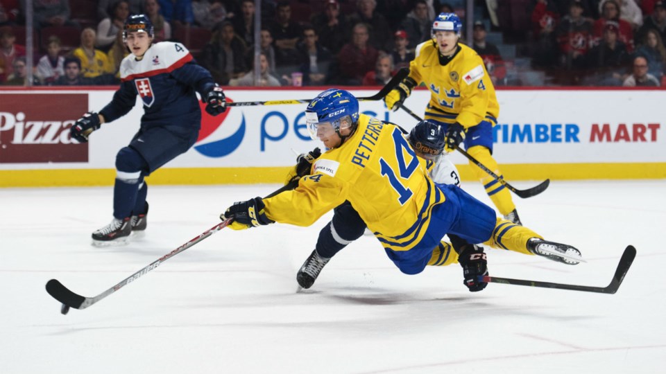 Elias Pettersson diving to make the play.