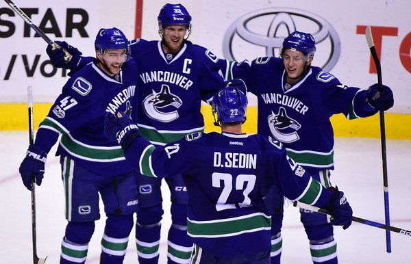 Sedins celebrate with Stecher and Baertschi