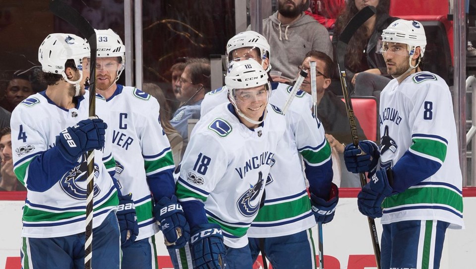 Jake Virtanen smiles after scoring his first goal of the season.