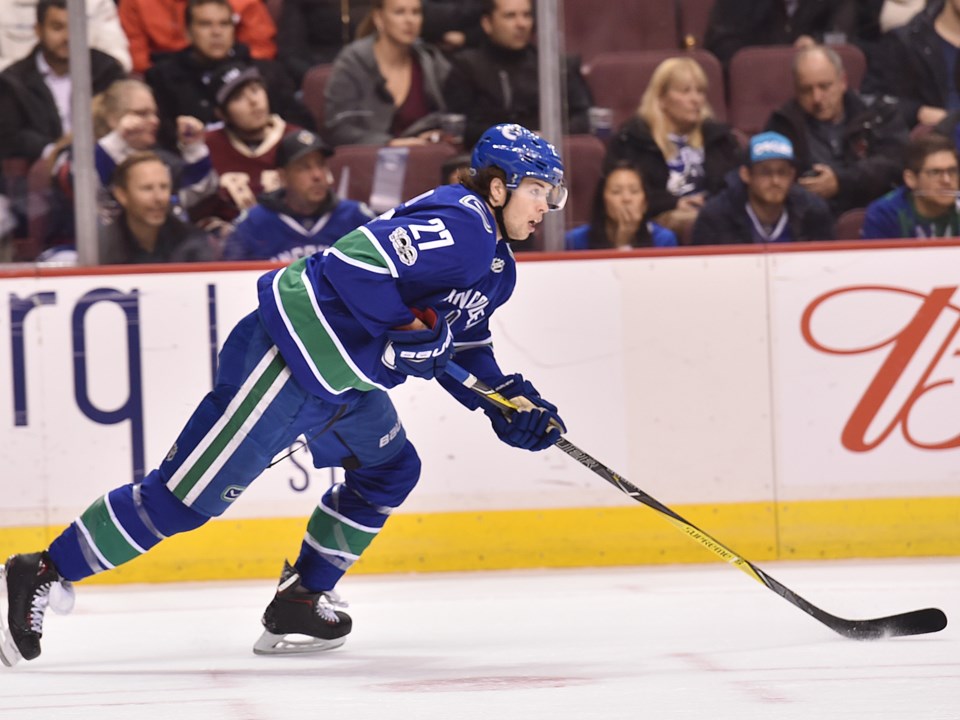 Ben Hutton skates the puck up ice for the Canucks.