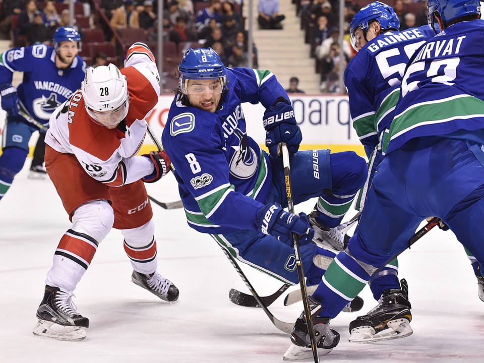 Vancouver Canucks Chris Tanev falls to the ice in a game against the Carolina Hurricanes