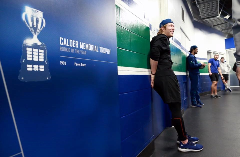 Brock Boeser next to the Calder Trophy wall