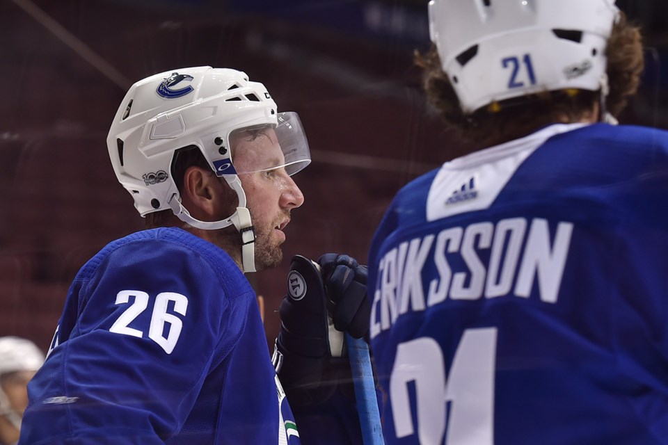 Thomas Vanek stands with Loui Eriksson at Canucks practice.