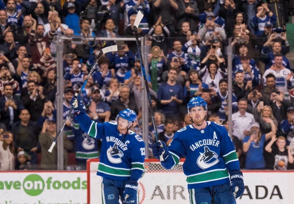 Daniel and Henrik Sedin salute the crowd at their final home game.