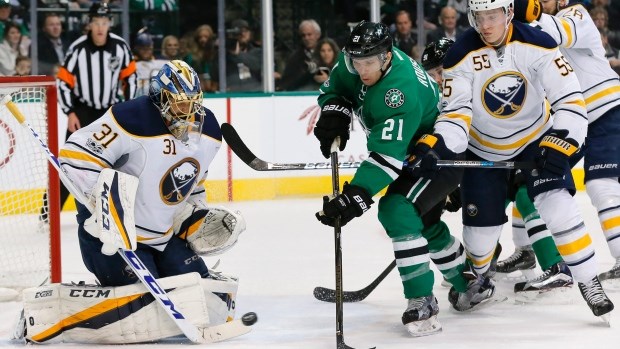 Antoine Roussel of the Dallas Stars battles for the puck in front of the Buffalo Sabres net.