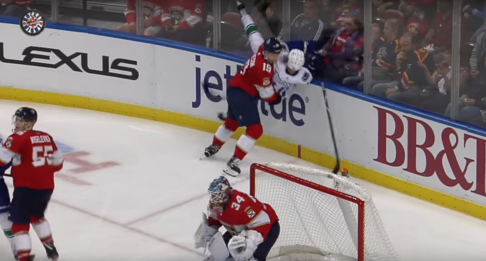 Michael Matheson slams Elias Pettersson to the ice in a game between the Panthers and Canucks.