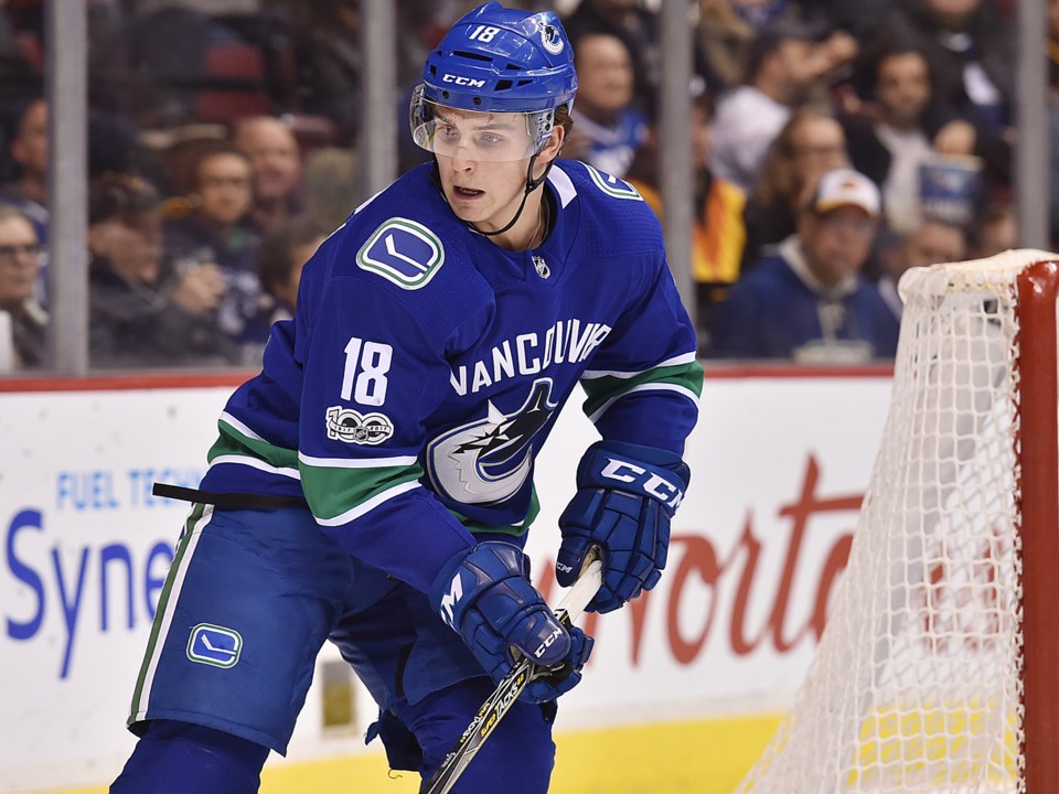 Jake Virtanen eyes the puck for the Vancouver Canucks