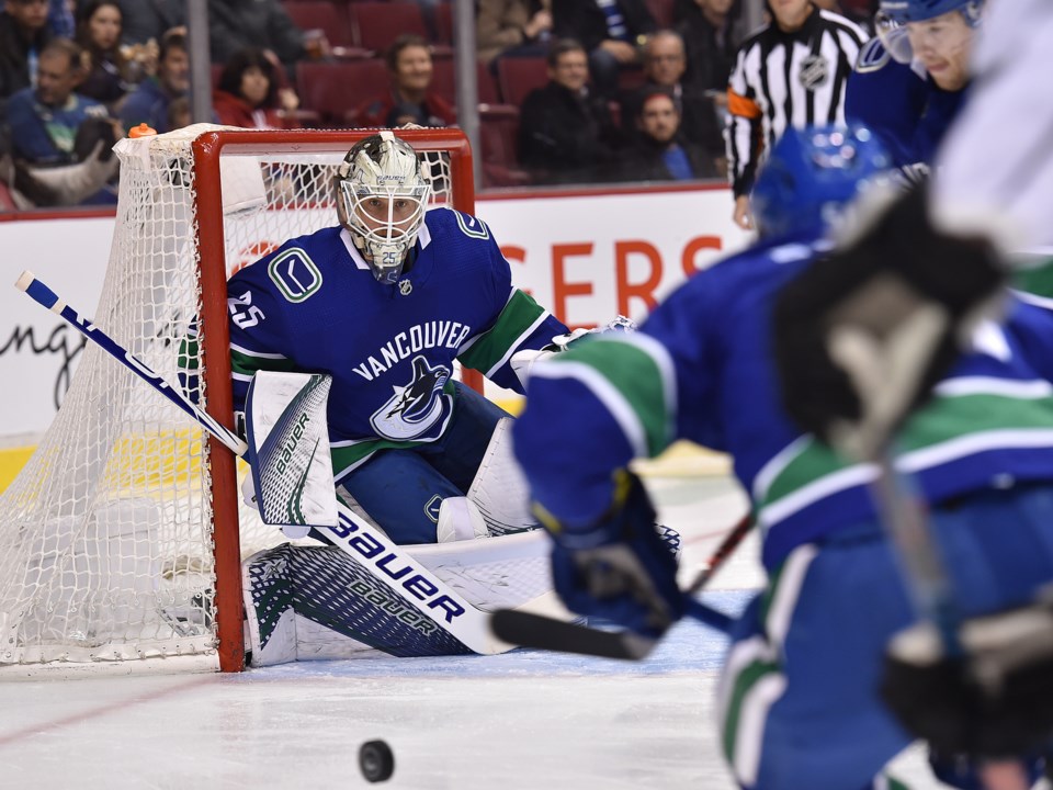 Jacob Markstrom stares down the puck in the Vancouver Canucks net.