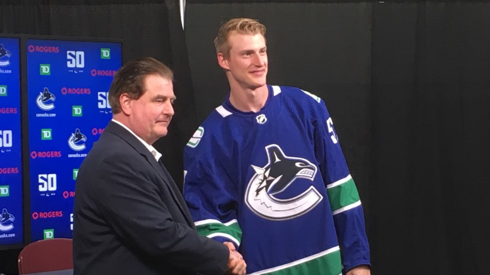 Tyler Myers shakes Jim Benning's hand after signing with the Vancouver Canucks.