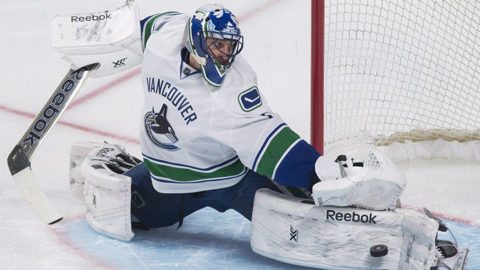 Roberto Luongo makes a save for the Vancouver Canucks.