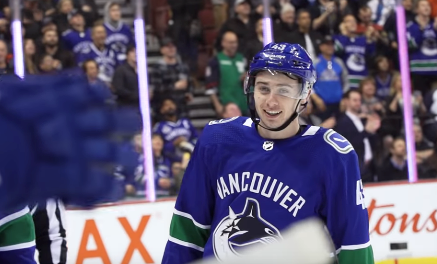 Quinn Hughes celebrates his first NHL point.