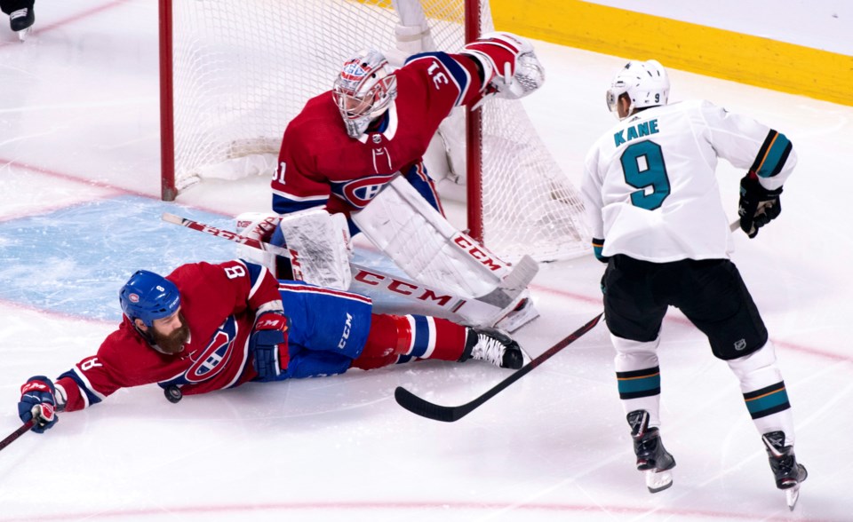 Jordie Benn slides to block Evander Kane's pass.