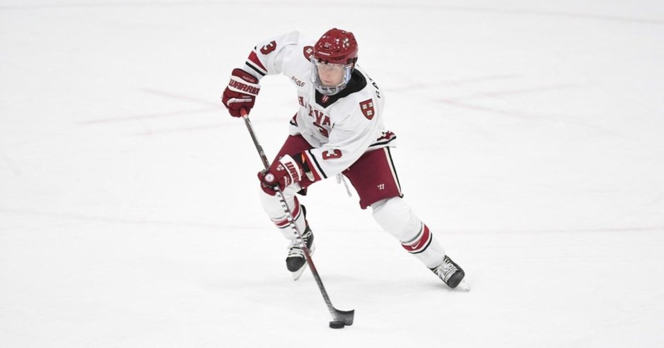 Jack Rathbone handling the puck for the Harvard Crimson.