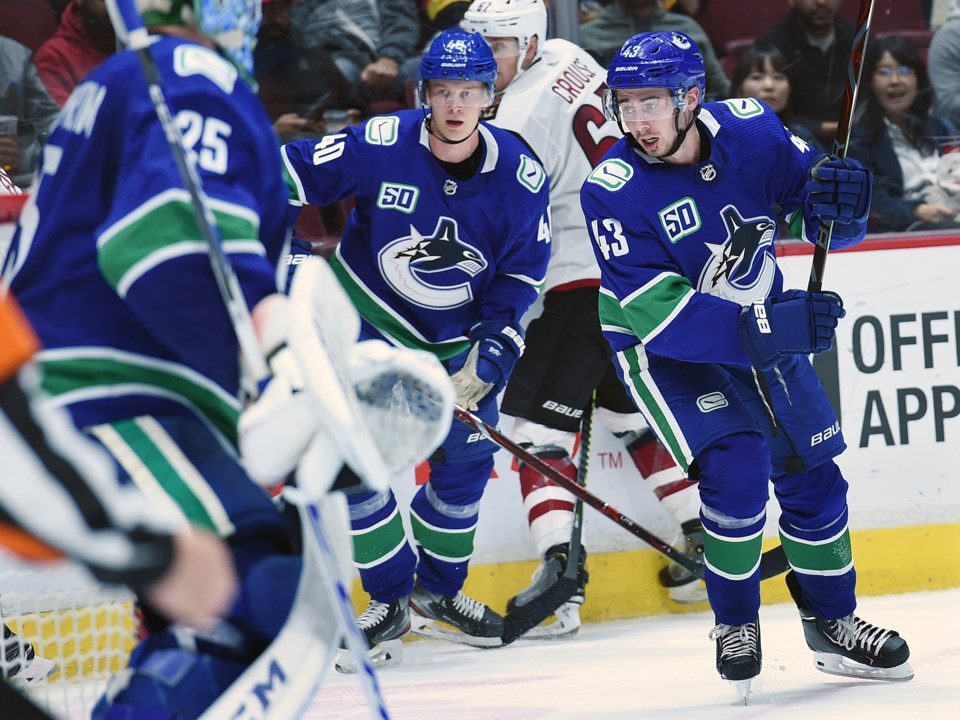 Elias Pettersson and Quinn Hughes chase down the puck in the Canucks 2019 preseason.