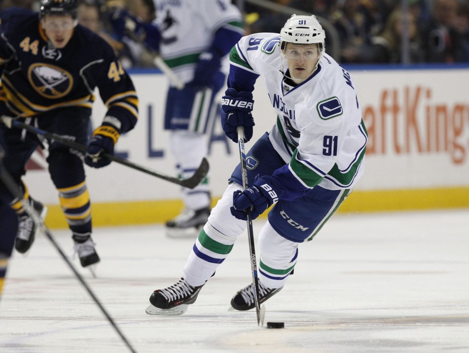 Jared McCann skates with the puck