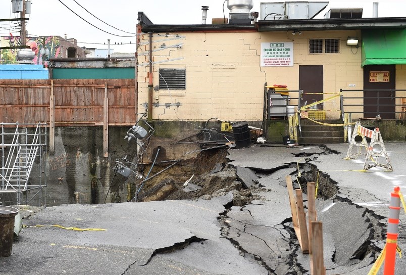  On Jan. 31, the retaining wall of a construction site came down during heavy rainfall on, causing a section of the Congee Noodle House parking lot to cave in and slide into the neighbouring excavation pit. Photo Dan Toulgoet