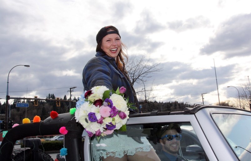 Julie Herberts and her new husband Brady drive through a receiving line arranged for them at Coquitlam Centre Saturday after their wedding reception had to be postponed due to COVID-19. Photo submitted